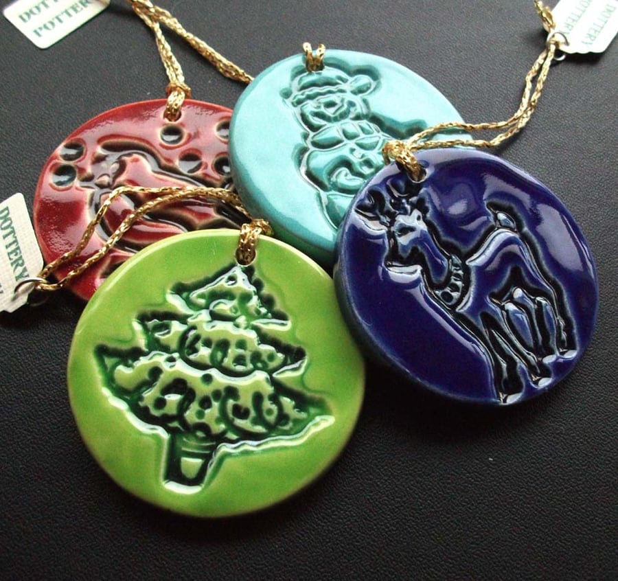 Set of four bright ceramic Christmas decorations