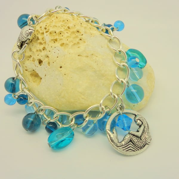 Charm bracelet with turquoise glass beads, a mermaid & fish clasp