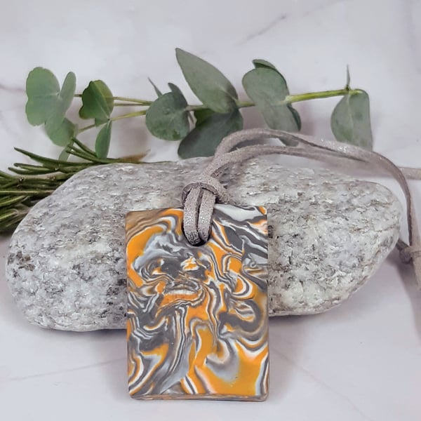 Orange and silver rectangular pendant