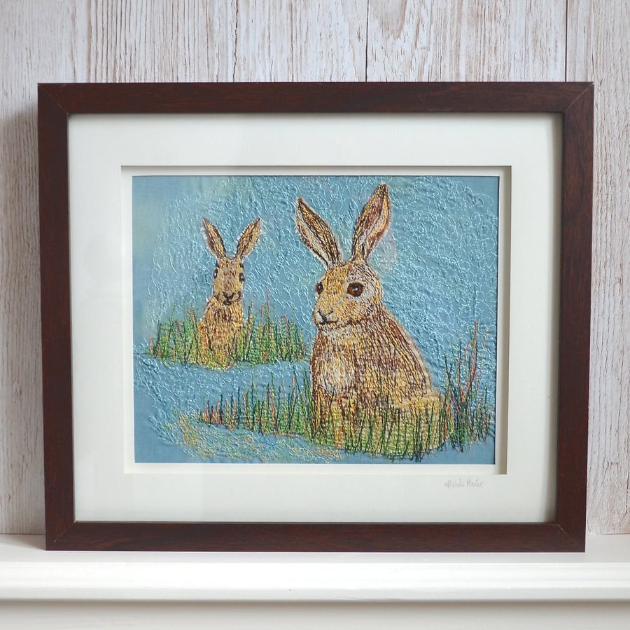 Two hares among the grasses - hand dyed and free motion textile embroidered art