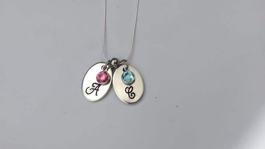 Hand stamped personalised oval initial necklace with swarovski crystal birthston