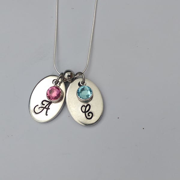 Hand stamped personalised oval initial necklace with swarovski crystal birthston
