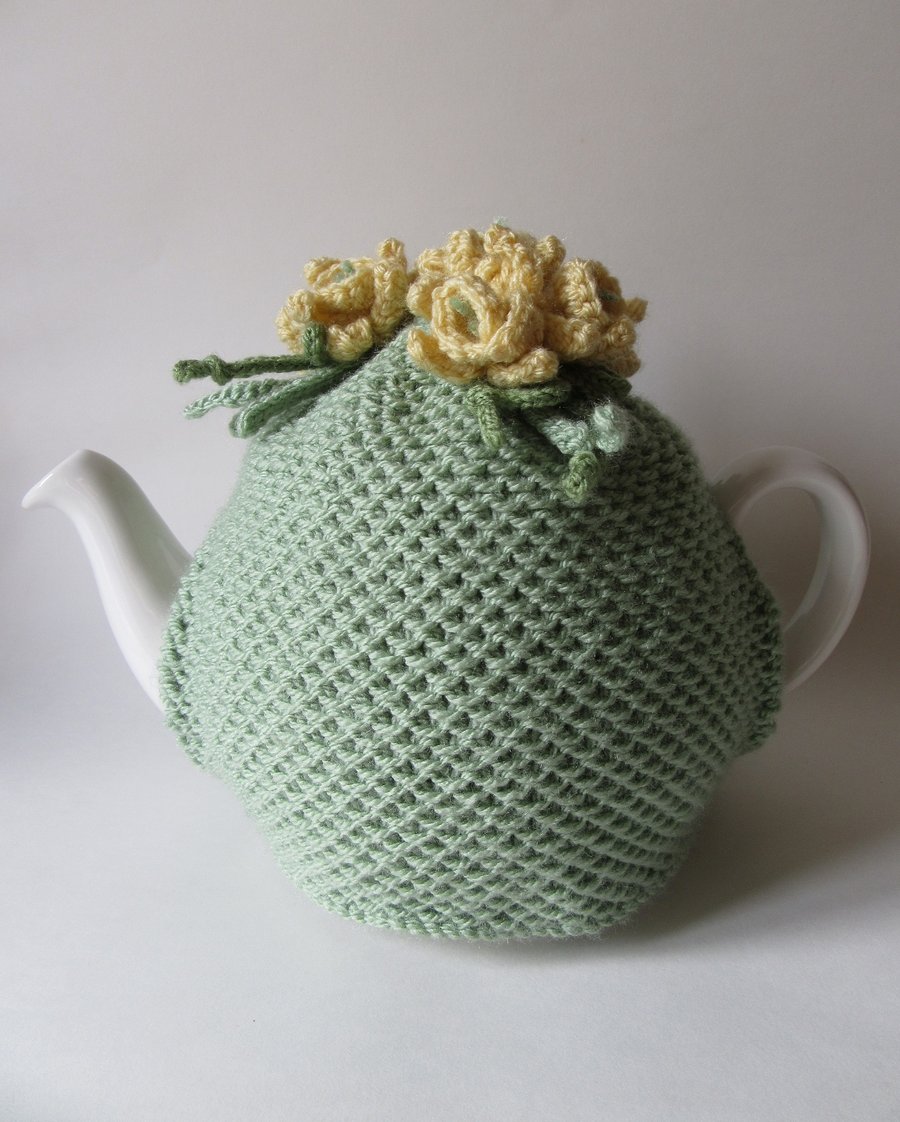 Hand knitted green tea pot cosie with daffodils