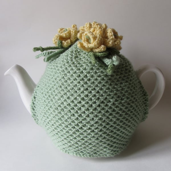 Hand knitted green tea pot cosie with daffodils