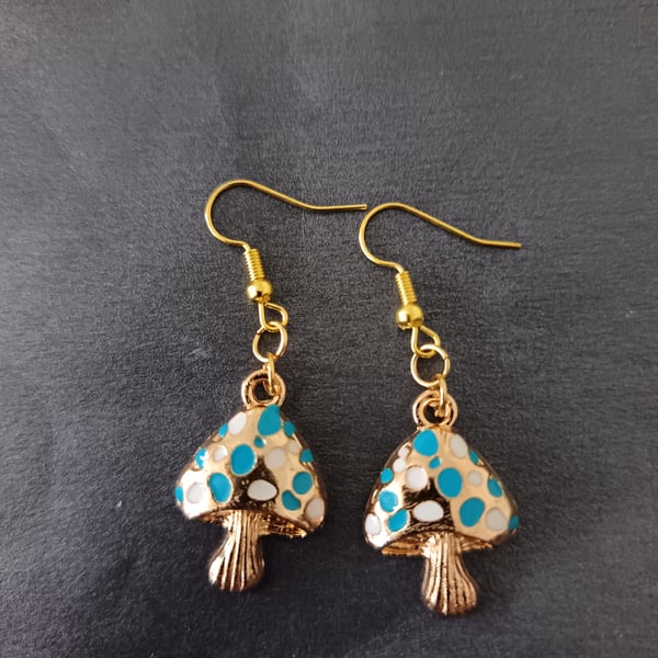Gold toadstool charm dangle earrings with white and blue spots 