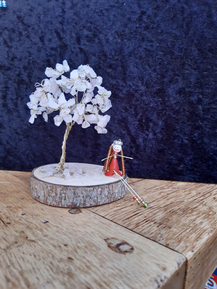 Rose quartz tree with little lady sitting by it