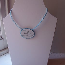 Textile necklace, oval shaped, hand and machine embroidered