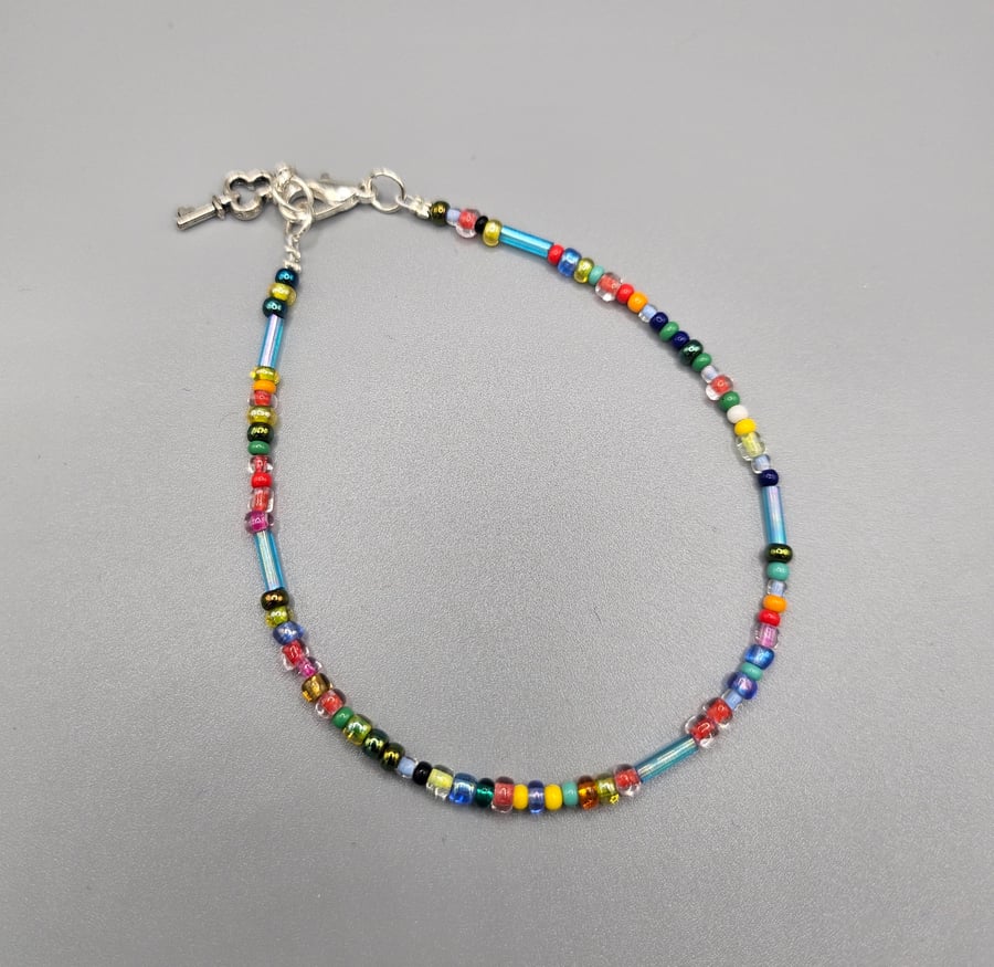 Multi-coloured beaded bracelet with charm