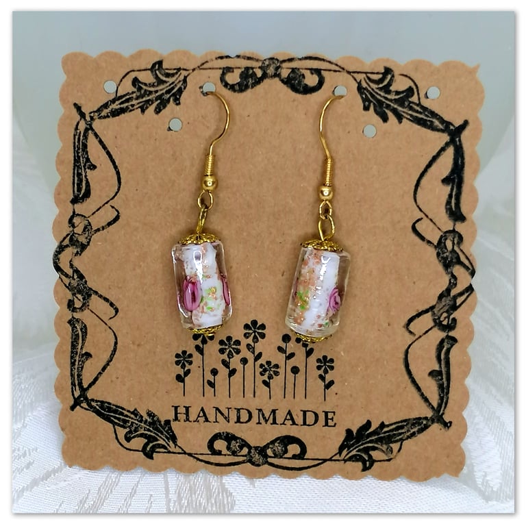 Handmade earrings with Murano Glass cylinder shaped beads with flower pattern.