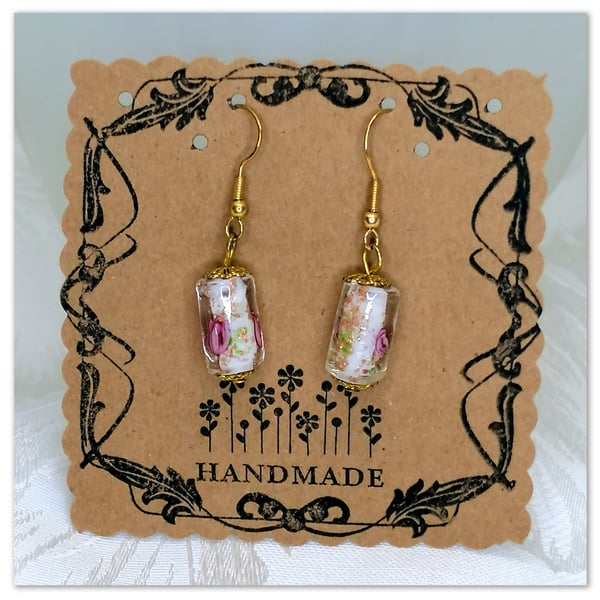 Handmade earrings with Murano Glass cylinder shaped beads with flower pattern.