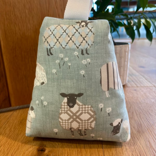 Cotton fabric doorstop in duck egg blue, fun sheep print, filled with pebbles