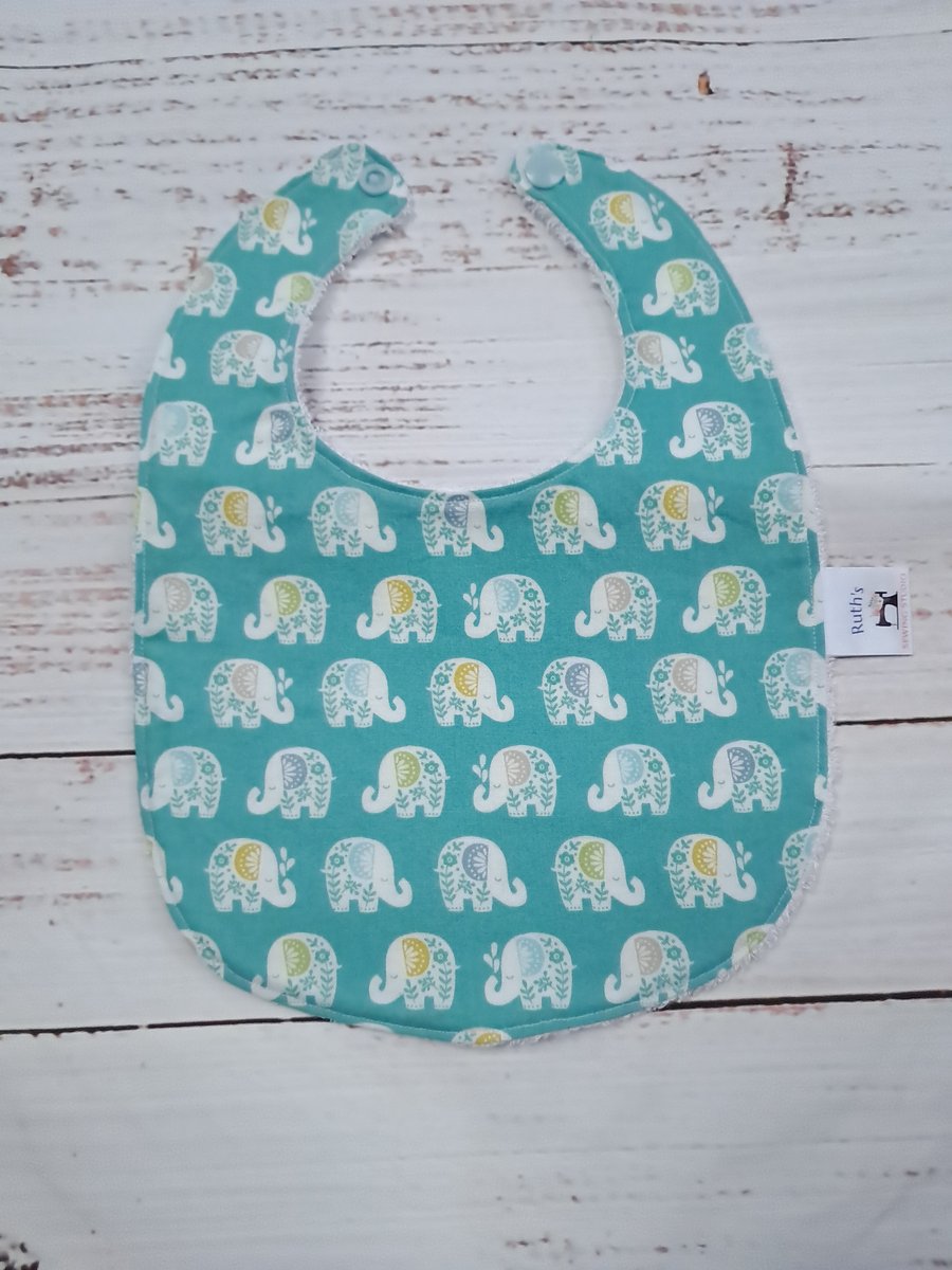 Unisex newborn baby bib with elephants on green