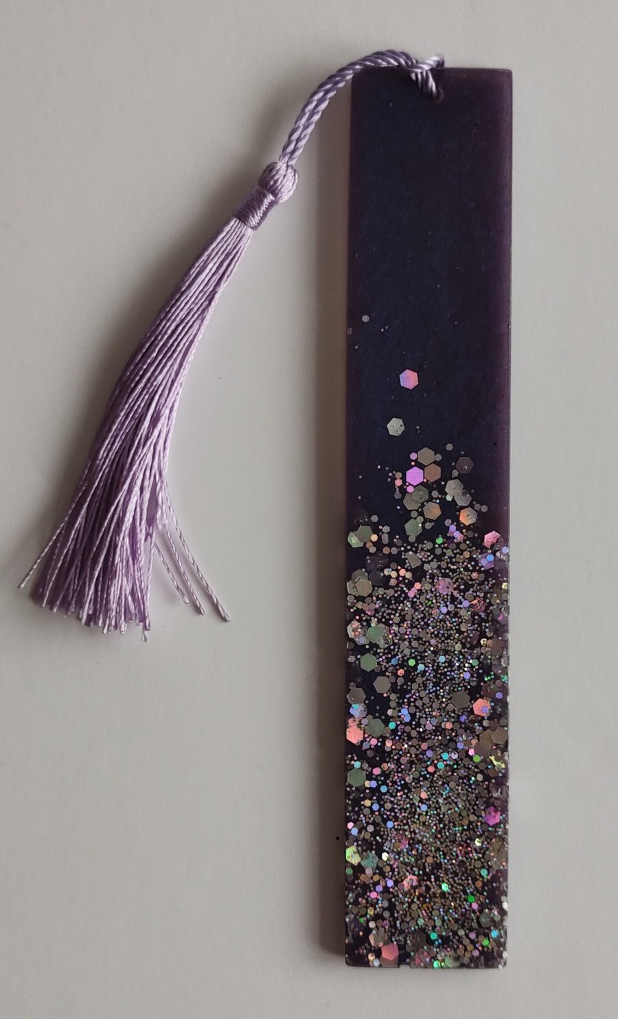Handmade resin bookmark in royal purple with holographic multicoloured sparkles.