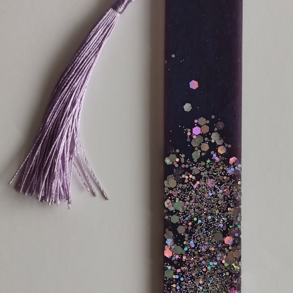 Handmade resin bookmark in royal purple with holographic multicoloured sparkles.