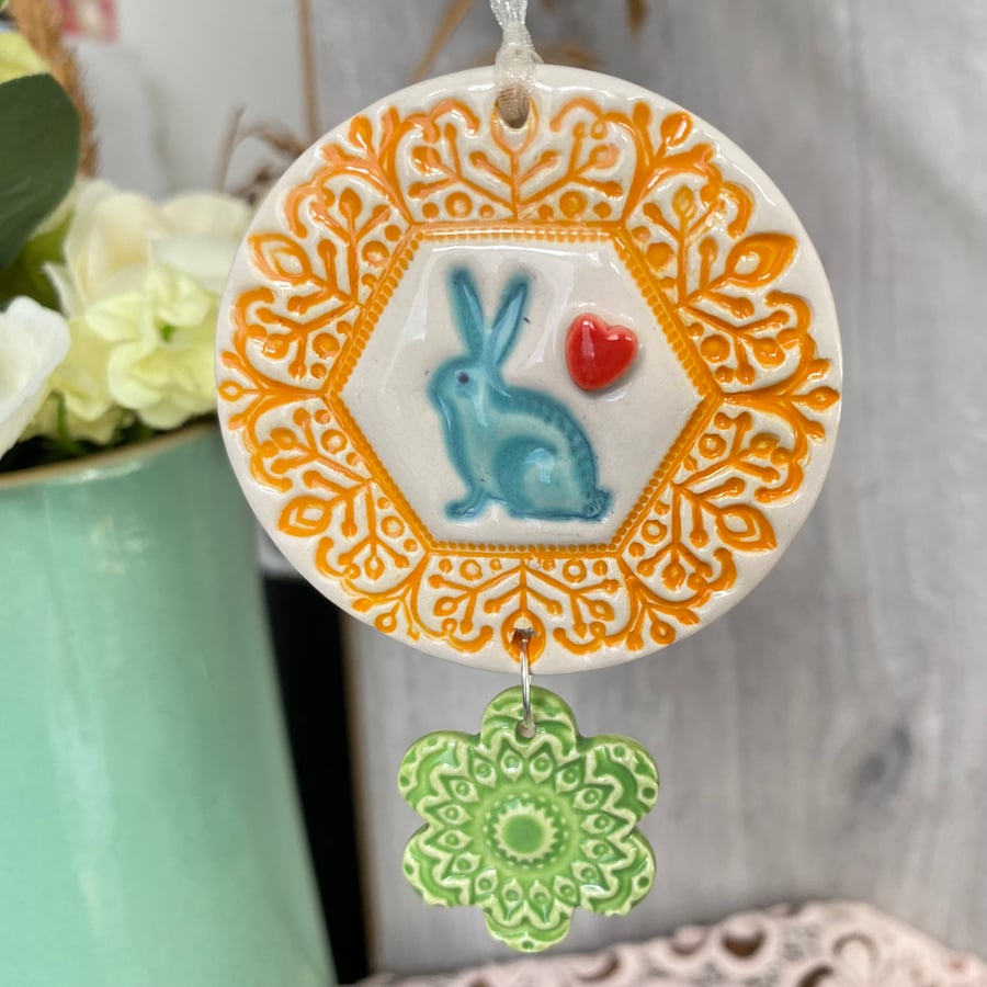 Ceramic decoration with rabbit and flower orange