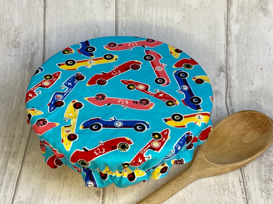 One small reusable bowl cover to fit a cereal-sized bowl. Racing cars