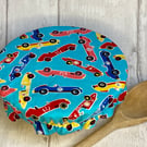 One small reusable bowl cover to fit a cereal-sized bowl. Racing cars