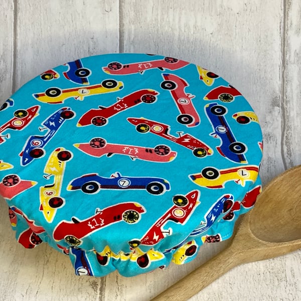 One small reusable bowl cover to fit a cereal-sized bowl. Racing cars