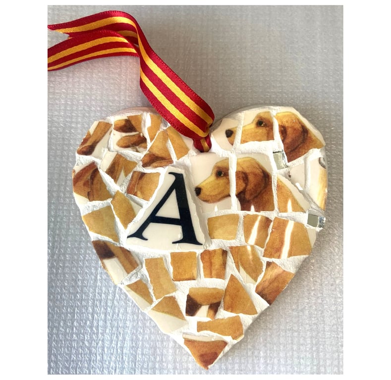 A heart shaped pendant with a Golden Labrador theme.