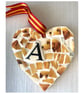 A heart shaped pendant with a Golden Labrador theme.