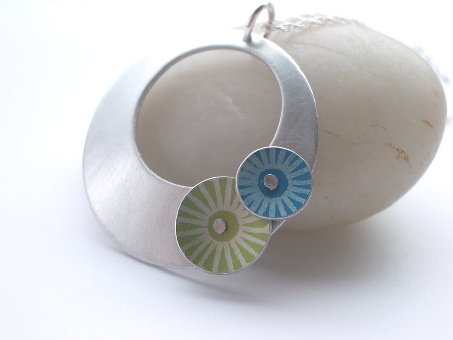 Circle pendant necklace in brushed aluminium with blue and green discs