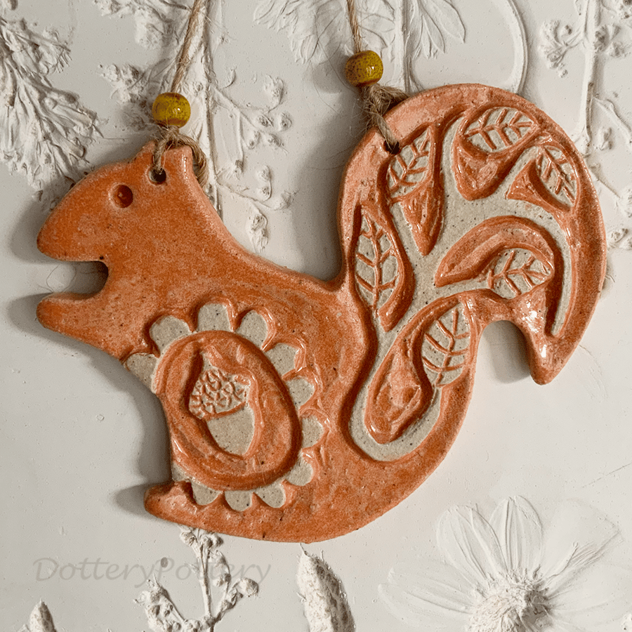 Ceramic squirrel decoration with carved design
