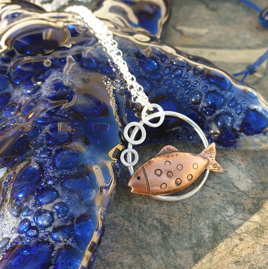 Silver and copper swimming fish pendant
