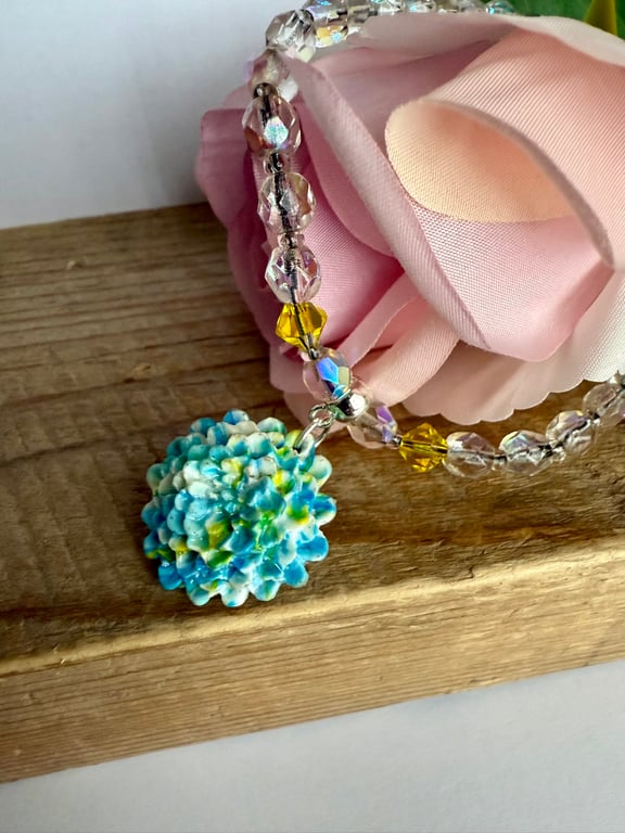 Polymer Clay Flower Pendant on a Aurora Borealis Necklace