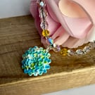 Polymer Clay Flower Pendant on a Aurora Borealis Necklace