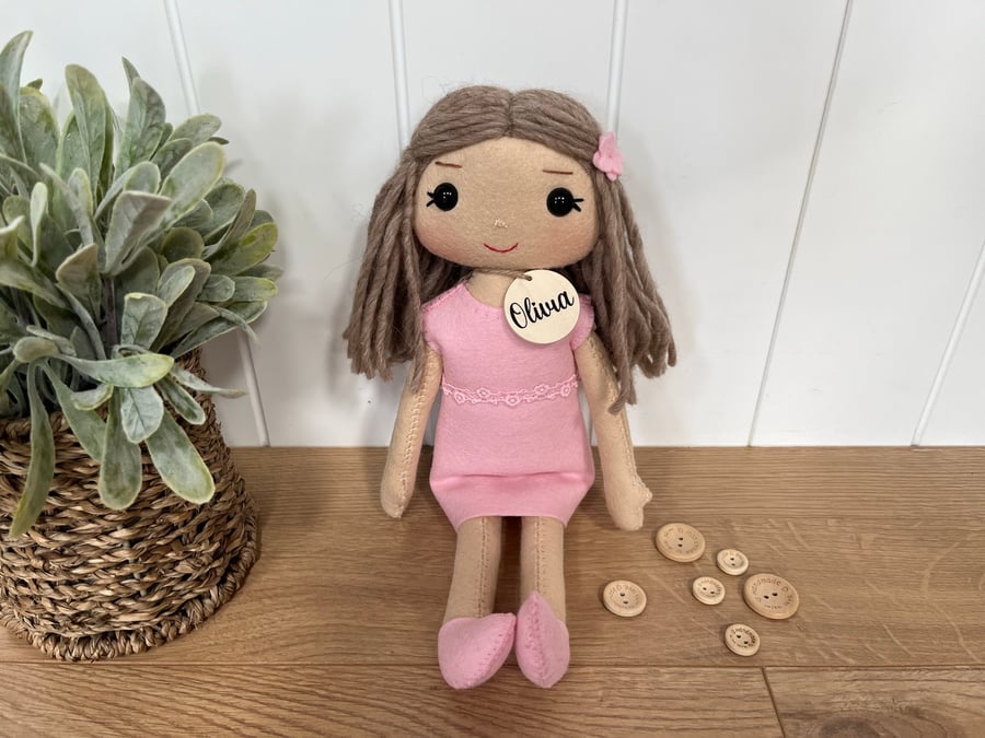 Handmade rag doll with pink wool felt dress