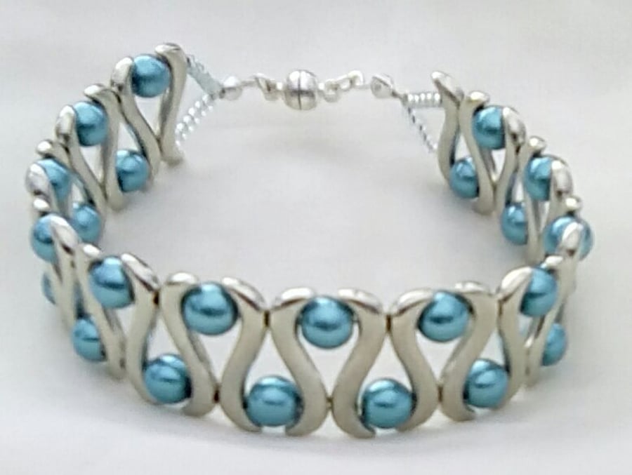 Bracelet made with turquoise glass pearls and silver plated spacers.