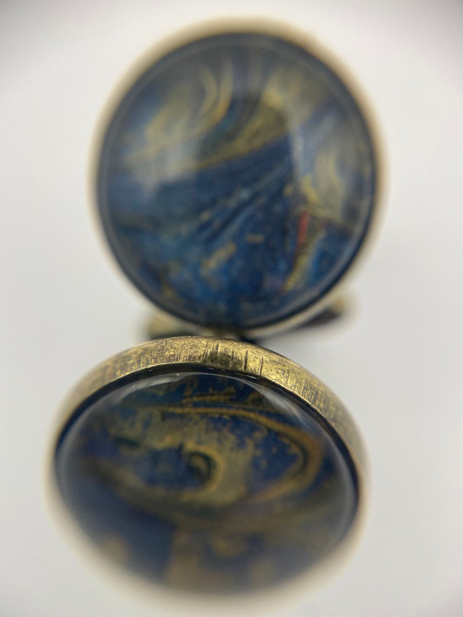 Pair of cuff links with blue and gold pigments 