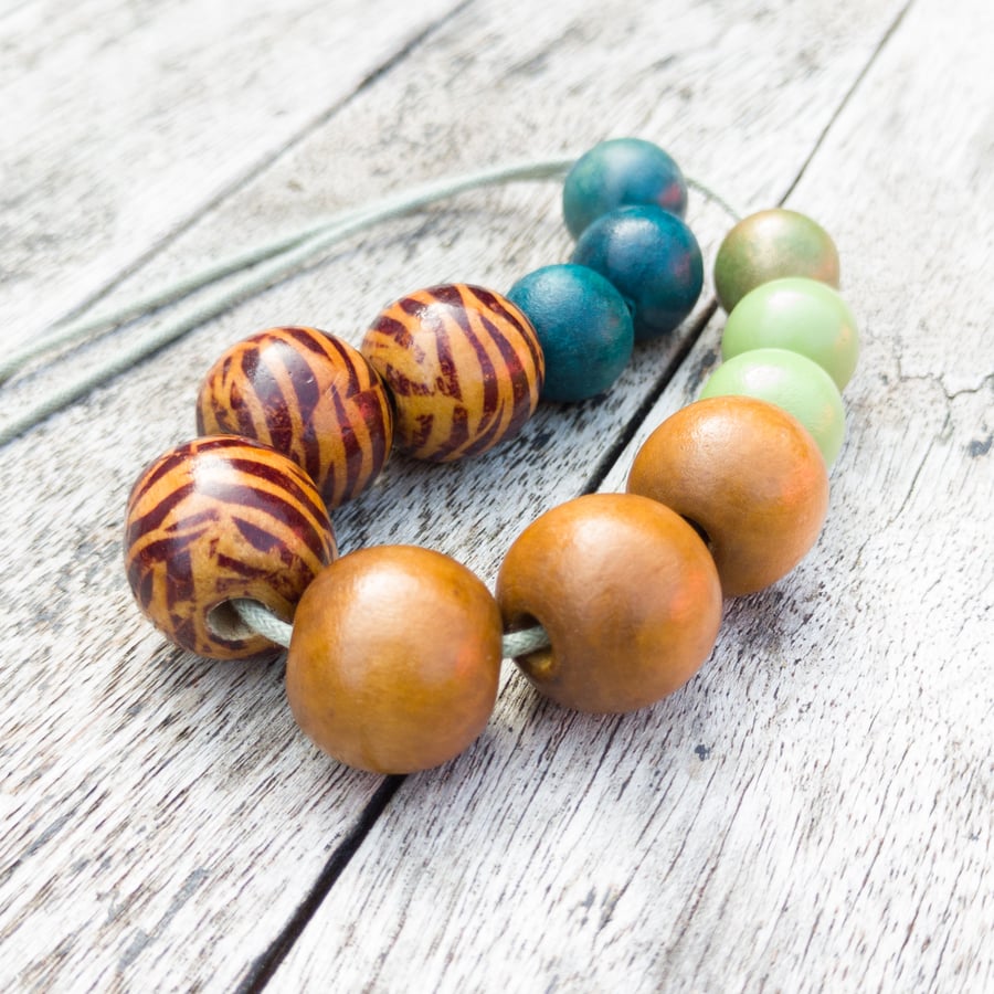 Tigi - Wooden bead necklace, green, blue and golden brown with zebra beads 