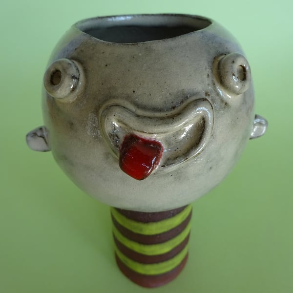 Ceramic face pot with licking out tongue