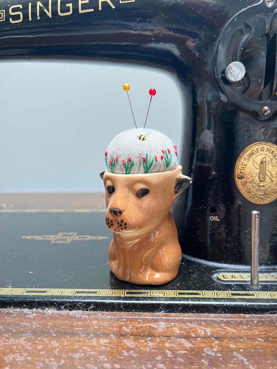 Pin cushion in a vintage dog or lion cub egg cup embroidered flowers and bee
