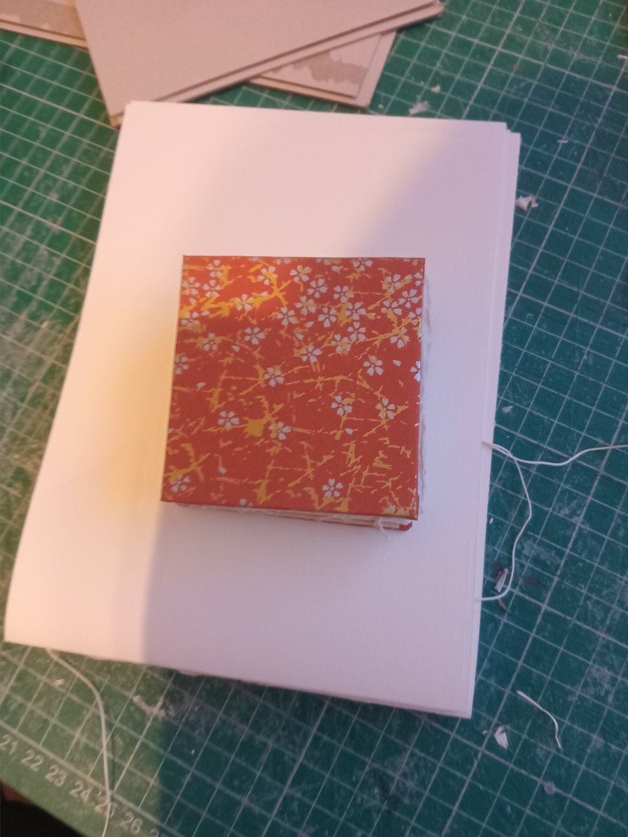 Mini sketchbook approx 8 cm square with cotton rag paper inside open spine 
