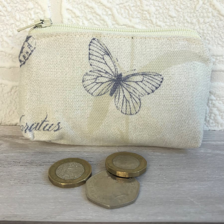 Small purse, coin purse in cream with small dark blue butterfly