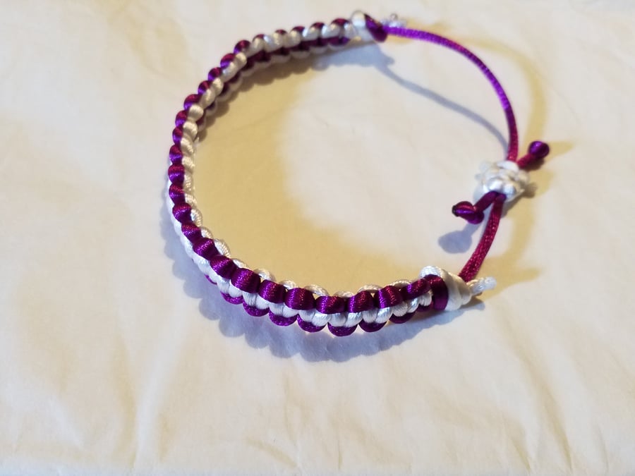 Handmade plum purple reversible and adjustable macrami bracelet.