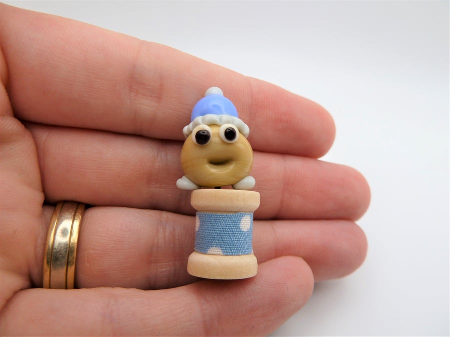 small glass blob in bobble hat 