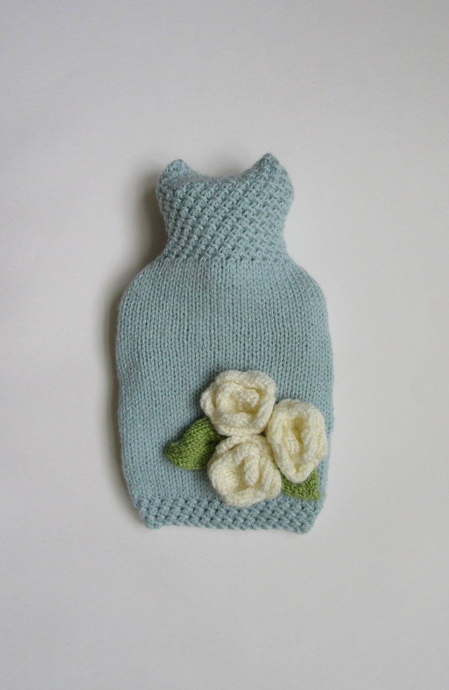 Duck egg blue hot water bottle cover with three cream roses.