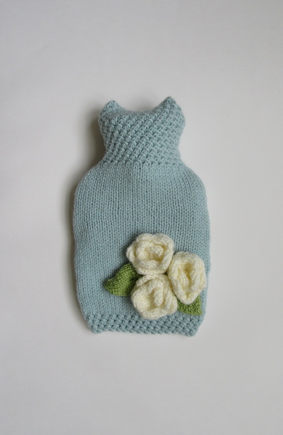 Duck egg blue hot water bottle cover with three cream roses.