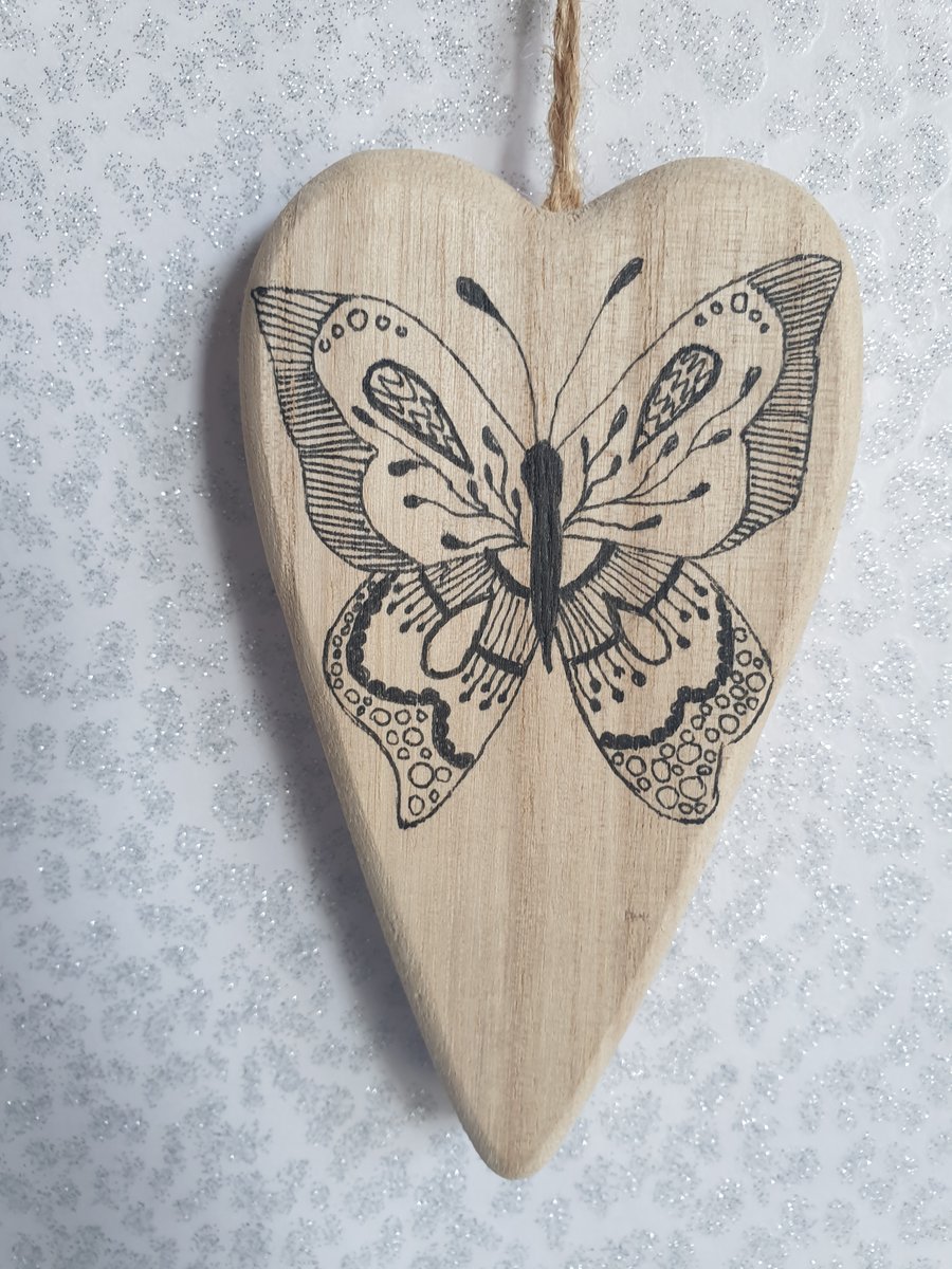 Hand drawn butterfly wooden heart