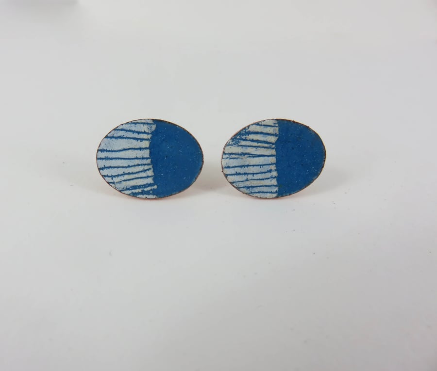 Oval turquoise enamel stud earrings with white drawn detail.