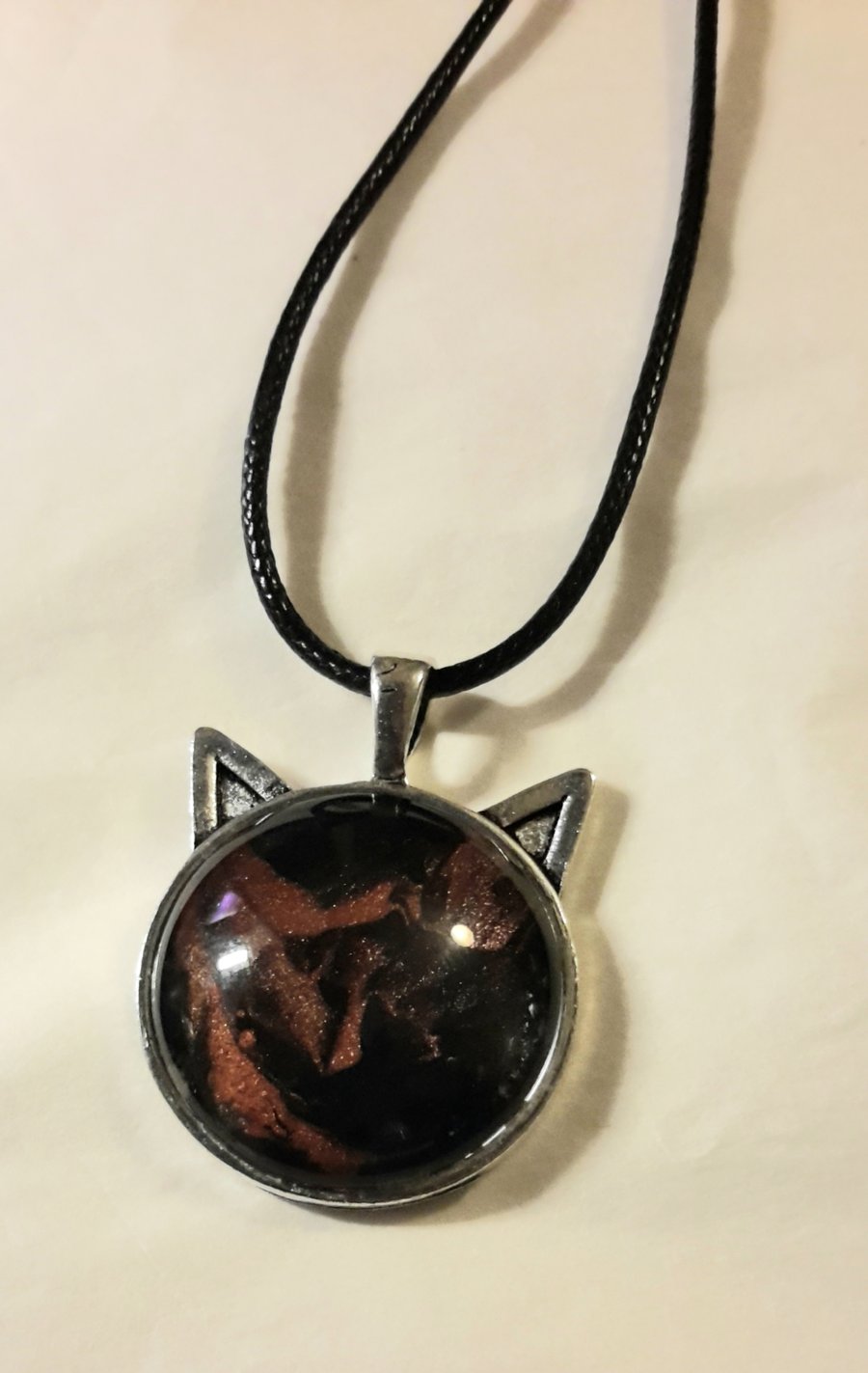 Handmade fluid art cat face pendant, copper and black.