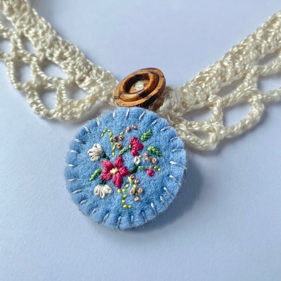 Crochet lace collar with blue embroidered wool felt pendant