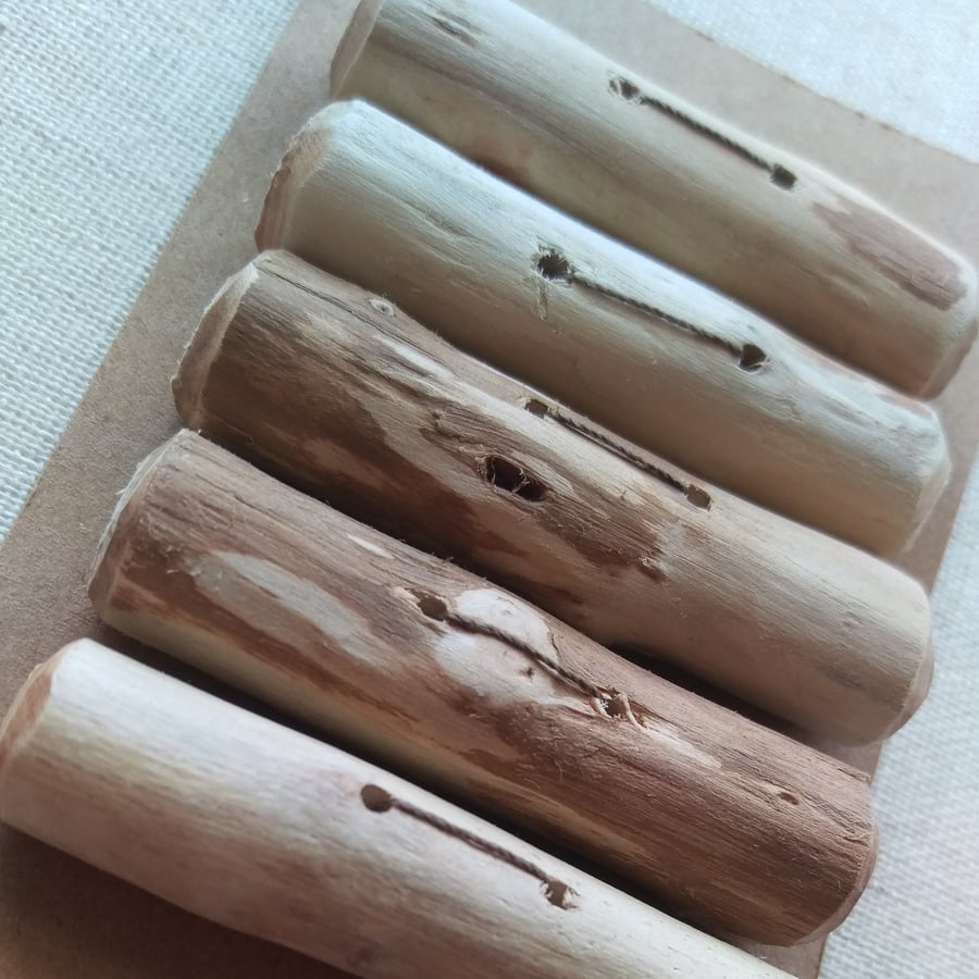 A set of five driftwood toggle buttons