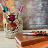 Textile storage pot with hand embroidered pheasant hiding in cornfield