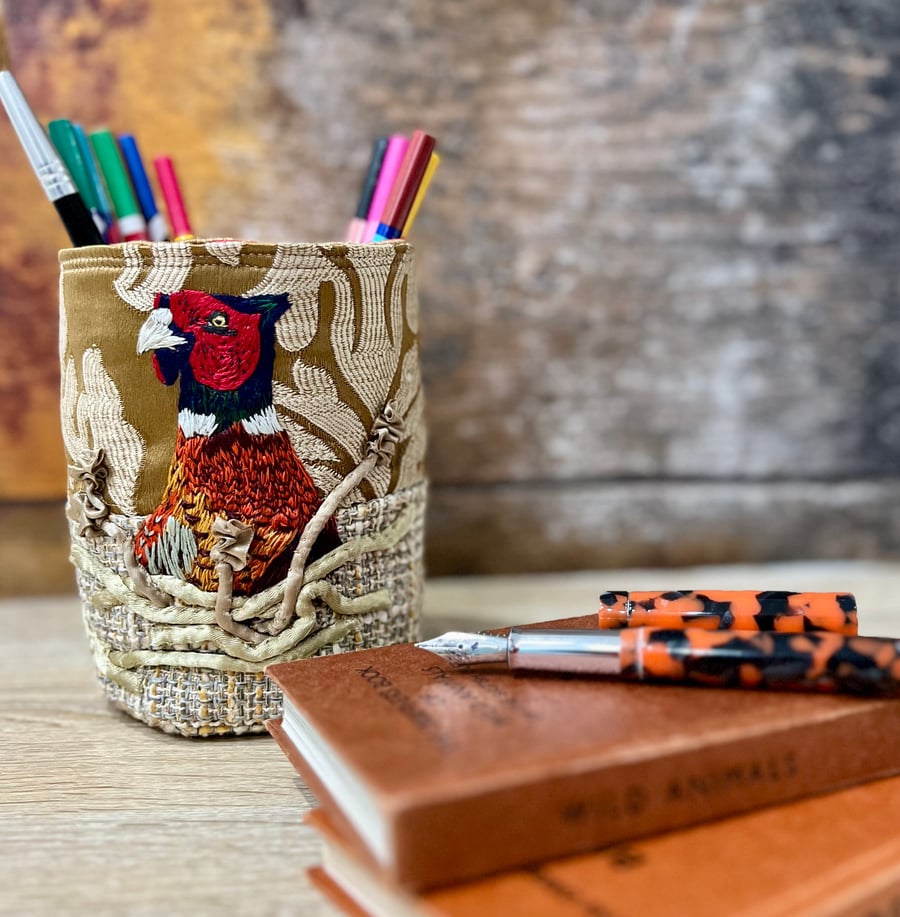 Textile storage pot with hand embroidered pheasant hiding in cornfield