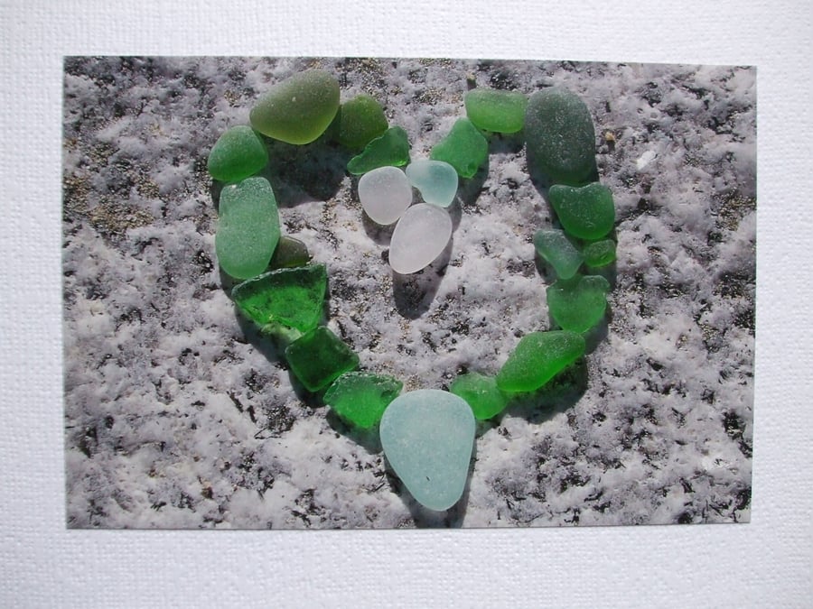  landscape photographic card of sea glass in a heart shape.