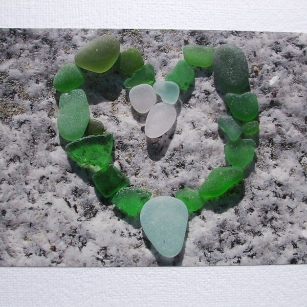  landscape photographic card of sea glass in a heart shape.